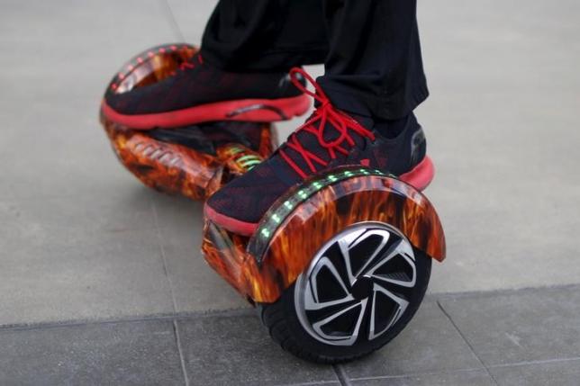 A boy rides a hoverboard in Santa Monica