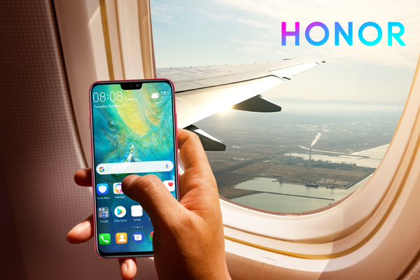 man hand holding smart-phone start up working  on board of airplane near window seat and wing