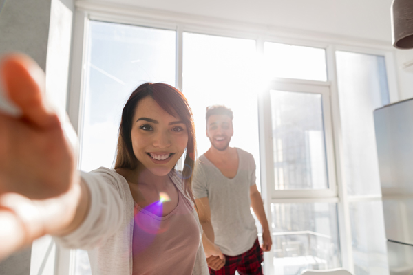 Young Couple Taking Selfie Photo Holding Hands In Kitchen, Asian