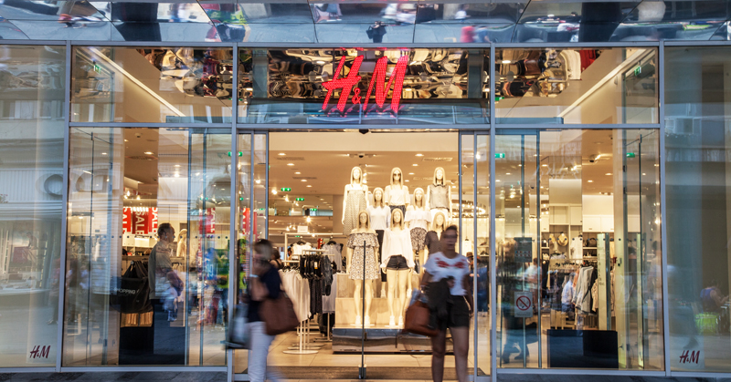 Clients going out of an H&amp;M store in the Serbian capital city, a giant logo of H&amp;M can be seen above the main entrance
