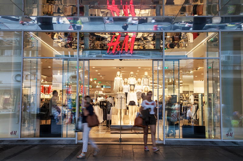 Clients going out of an H&amp;M store in the Serbian capital city, a giant logo of H&amp;M can be seen above the main entrance