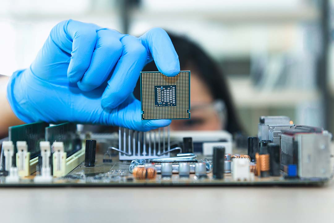 Close-Up Of Engineer Holding Computer Equipment On Table