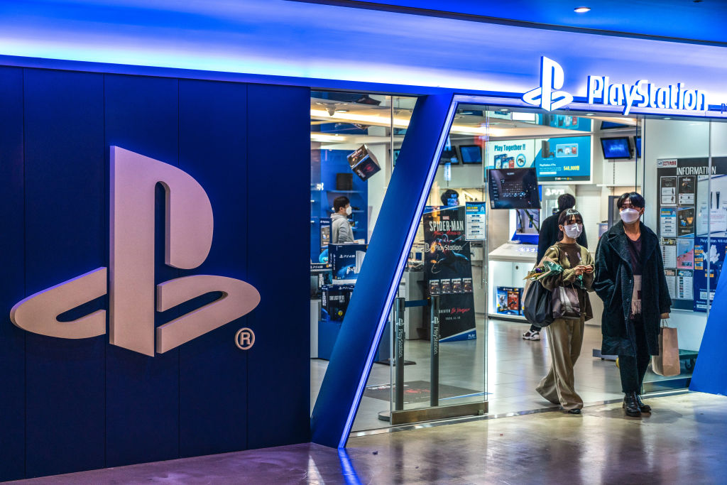 People wearing masks exit a PlayStation Store in Seoul