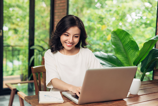 Female freelancer working in coffee shop. Student learning onlin