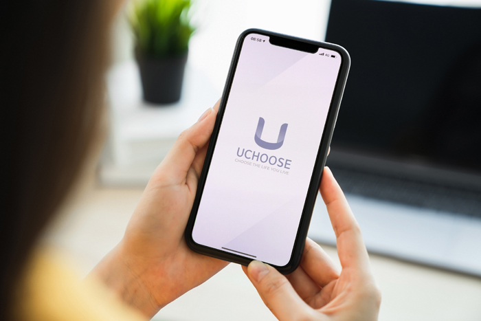 Woman,Hand,Holding,Smartphone,And,Touching,Blank,Screen.,Mockup,Of