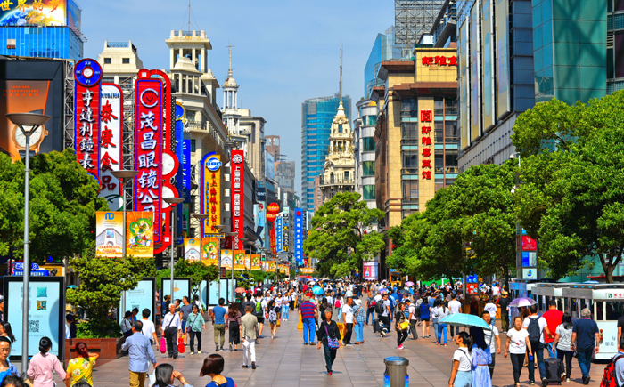 Commercial shopping street scene full of people in Nanjing Road. Nanjing Road is the main pedestrian shopping street in Shanghai and one of the world's busiest commercial streets. China