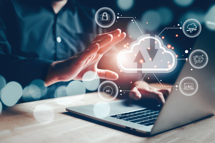 Businessman using laptop to access cloud computing and cybersecurity diagram graphic user interface screen. Connection and big data concept. Information Technologist touch hologram head up display