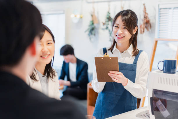 Young staff taking orders at a cafe